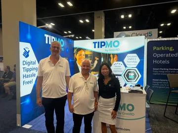 TIPMO by GratifID booth at HITEC 2026 — three team members in front of banners reading Digital Tipping Hassle Free and Encrypted NFC Technology